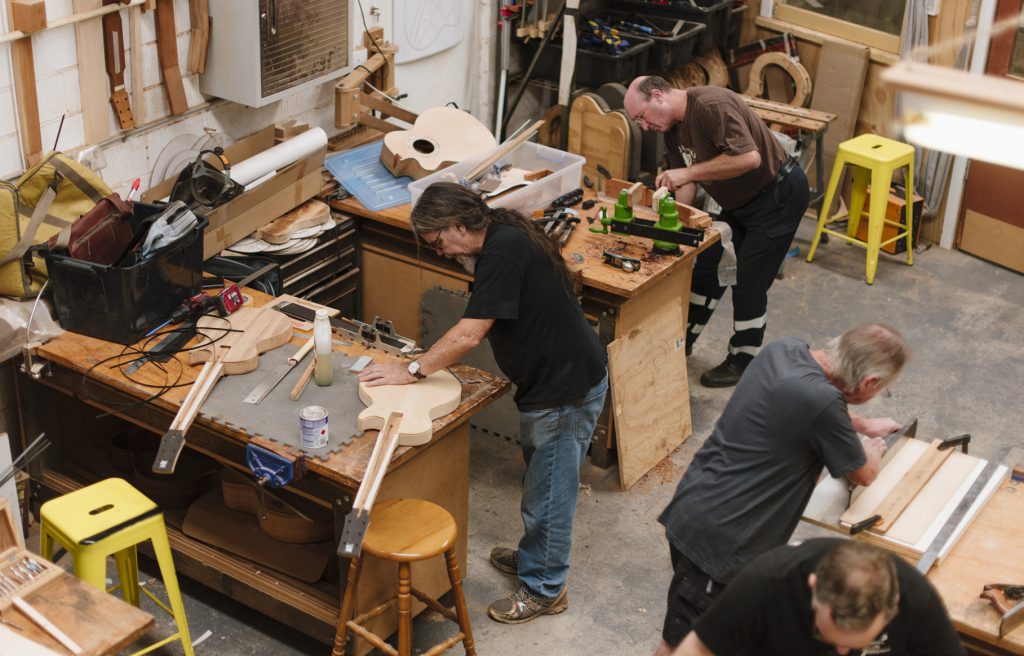 Students working on their guitars in the workshop